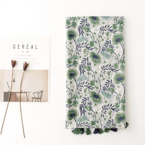 Fresh green floral cotton-linen scarf with blue tassels and elegant summer beach wrap style