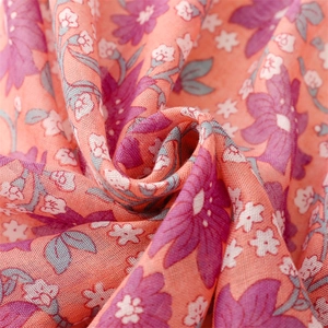 Detailed macro view of soft pink floral cotton linen fabric with delicate weave pattern