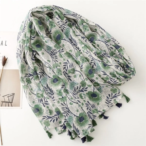 Elegant green floral beach scarf with blue tassels, soft cotton feel for sun protection