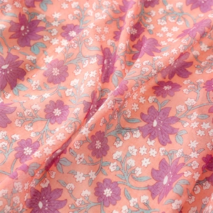 Close-up of pink floral scarf fabric showing soft texture and detailed flower print