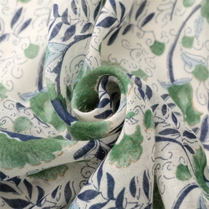 Detail of green leaf print fabric showing soft cotton-linen texture and woven weave