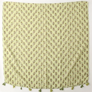 Pale yellow paisley beach shawl with green fringe trim and elegant floral patterns
