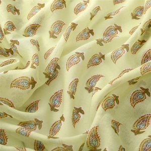 Close-up of lime green beach shawl fabric with artistic leaf print and soft texture