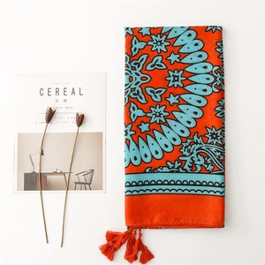 Ethnic style orange linen-touch shawl with blue floral patterns and tassel edges