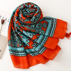 Bohemian paisley print shawl with orange tassels for travel and vacation styling