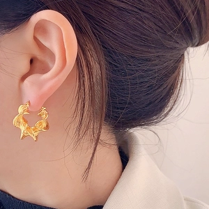 Chic geometric spiral twisted gold hoop earrings with a textured ribbon design for women