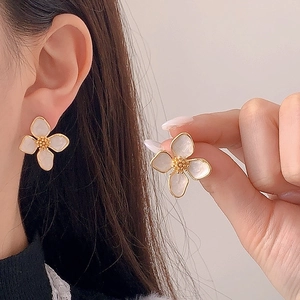 Minimalist four-petal enamel flower earrings with gold plating on female model