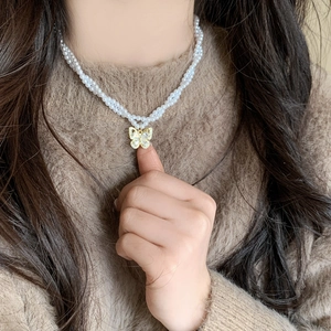 Double-layered pearl necklace with a gold butterfly zircon pendant for elegant women