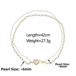Detail of double-layer pearl necklace with heart pendant and toggle clasp closure