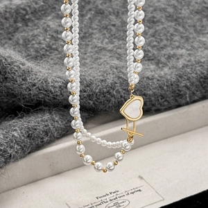 Double-layered pearl necklace with golden heart pendant and retro toggle clasp