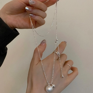 Silver minimalist long necklace featuring adjustable dual spheres with brushed texture