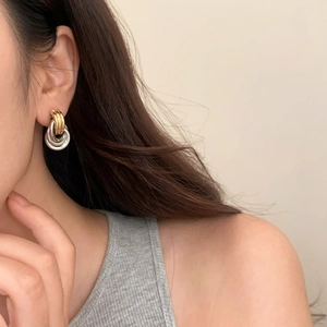 Chic two-tone geometric twisted triple hoop earrings for women in gold and silver finish
