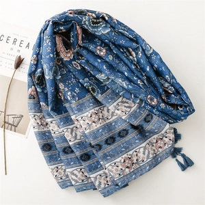 Bohemian blue floral shawl with tassels on white background with cereal magazine