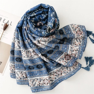 Blue porcelain style ethnic shawl scarf with floral patterns and tassels on white background