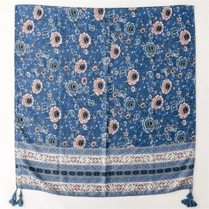 Detailed view of vintage blue floral linen shawl with delicate tassels and ethnic patterns