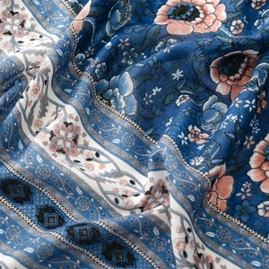 Detail of blue floral cotton linen fabric with vintage ethnic geometric patterns and texture
