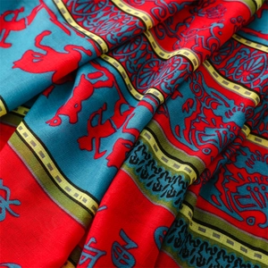 Detail of retro ethnic scarf showing artistic totem prints and soft twill fabric texture
