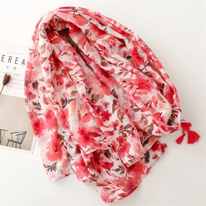 Detailed macro view of floral print scarf with soft tassels and striped texture