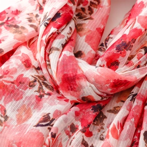 Macro shot of cotton linen floral scarf fabric showing fine texture and tassels