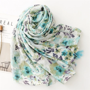 Detail of floral print scarf with soft fringe edges and vertical textured fabric