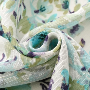 Macro detail of breathable cotton linen scarf with floral print and slub yarn texture