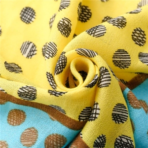 Macro shot of yellow and blue polka dot scarf fabric with detailed cotton-linen texture