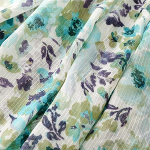 Detailed macro view of cotton-linen feel scarf featuring floral prints and striped texture