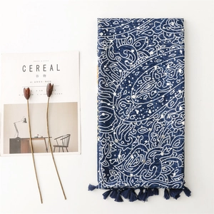 Detail of navy paisley patterned scarf with elegant fringe trim and bohemian print