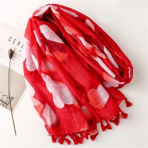 Red scarf with white heart prints and silver lurex stripes on white background