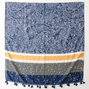 Detail of paisley pattern silk scarf with yellow dots and dark blue tassels