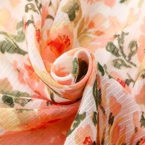 Macro detail of breathable cotton linen scarf with soft floral print and ribbed texture