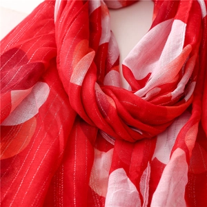 Macro shot of red heart print scarf featuring elegant silver lurex vertical stripes