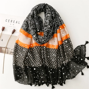 Lightweight scarf with golden paisley patterns, colorful patchwork, and tassel details