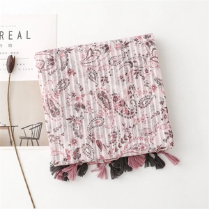 Close-up of pink and grey paisley pattern scarf with soft tassels and cotton-linen texture