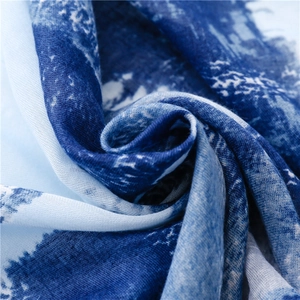 Detailed macro view showing the soft gradient dye texture and fine weave of the cotton scarf