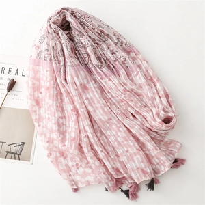Pink and white paisley linen scarf with floral print, tassels, and soft pleated texture