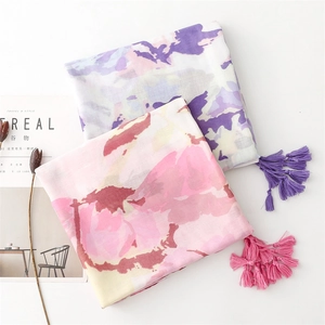 Detail of long soft cotton scarves with watercolor ink painting and tassel edge trim