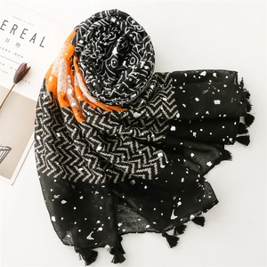 Lightweight scarf with gold foil accents, orange blocks, and tassels on a clean layout