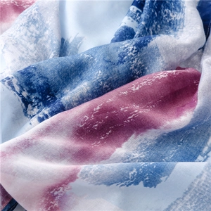 Detail of artistic watercolor print on soft gradient pashmina with silver stamping texture