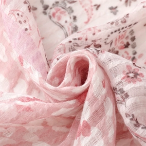 Close-up of pink floral and paisley patterns on soft breathable linen cotton fabric