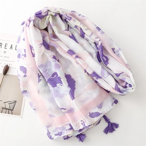 Detail of artistic purple and pink floral scarf with elegant fringe and cotton feel