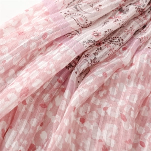 Close-up of pink paisley and floral patterns on soft cotton-linen scarf fabric