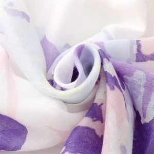 Macro shot of ink wash floral scarf showing soft cotton texture and purple ink prints