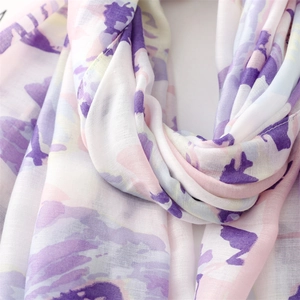 Close-up of lightweight purple and pink floral print fabric with soft weave texture