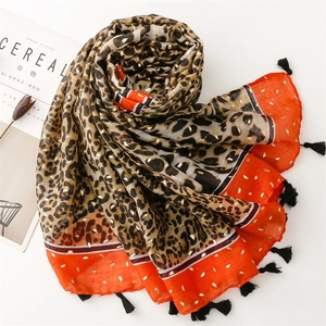 Écharpe léopard dorée pour femme avec bordure orange et élégants glands noirs