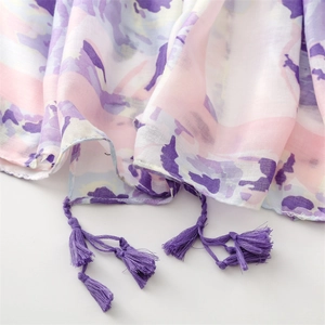 Detailed view of floral ink painting silk cotton shawl with purple tassel decorative trim