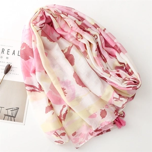 Detail of pink and white ink print scarf with soft fringe edges and crinkle texture