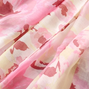 Close-up of floral ink painting pattern on soft cotton scarf showing fine fabric texture