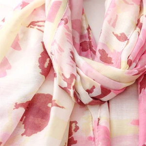 Detailed macro view showing the soft texture and ink floral pattern of the silk shawl