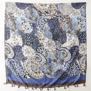 Blue geometric mandala pattern chiffon scarf with delicate fringe trim on white background